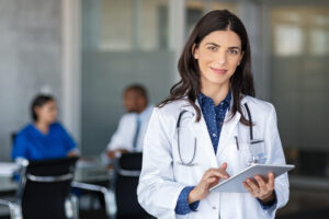 Doctor holding digital tablet at meeting room