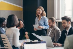 Happy group of business people discussing strategy during team meeting at the office together